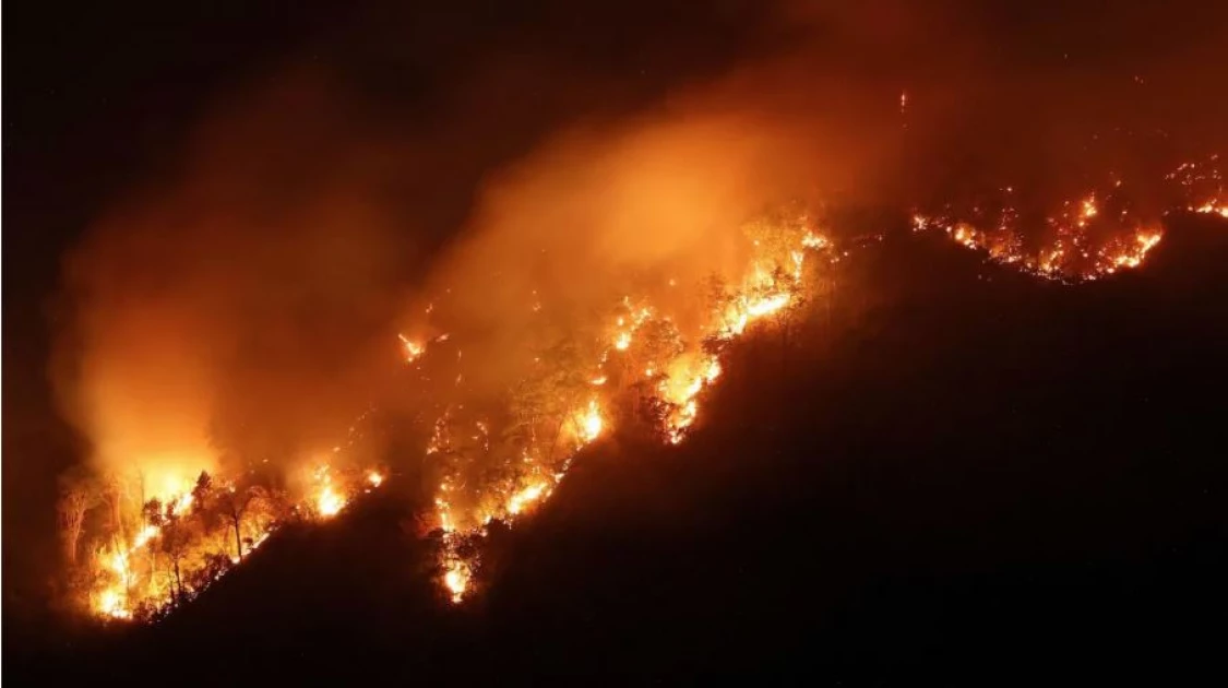 Thai firefighters battle huge forest blaze that spread across two mountains